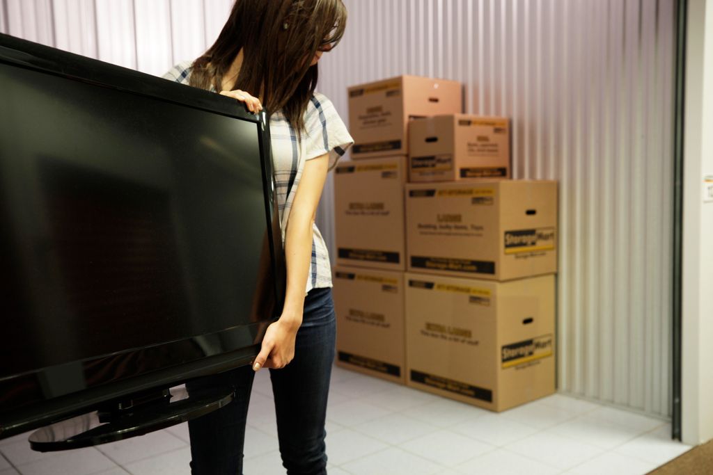 College student moving a TV into her StorageMart unit