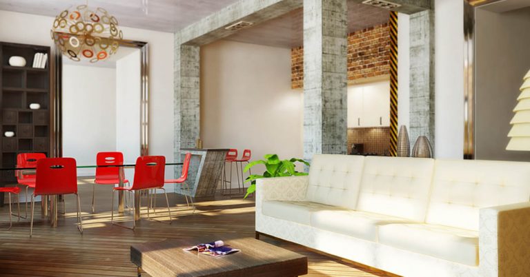An elegant room furnished a cream-colored sofa and red dining chairs.
