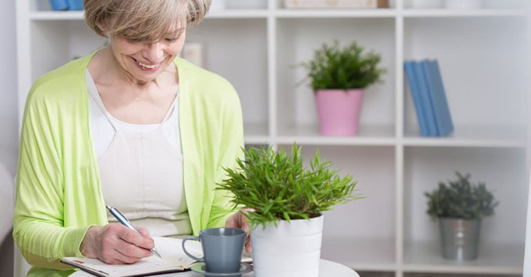 A woman writes in her journal.