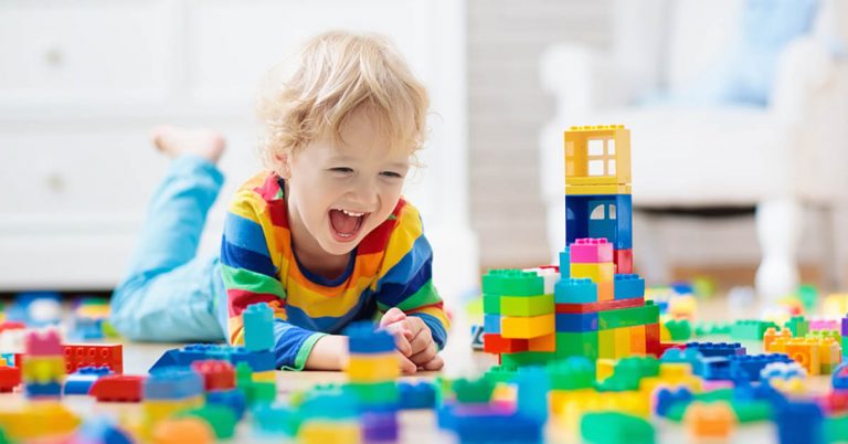 A young boy plays with building blocks.